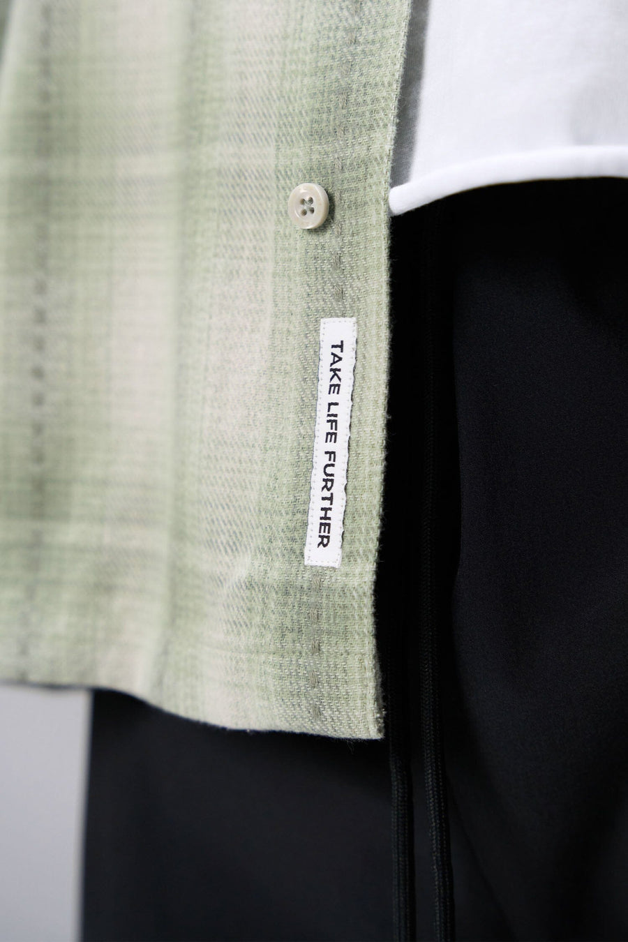 Front View of the Green TLF GTS Flannel Shacket crafted in premium cotton plaid flannel with elevated embroidery details on the collar and back