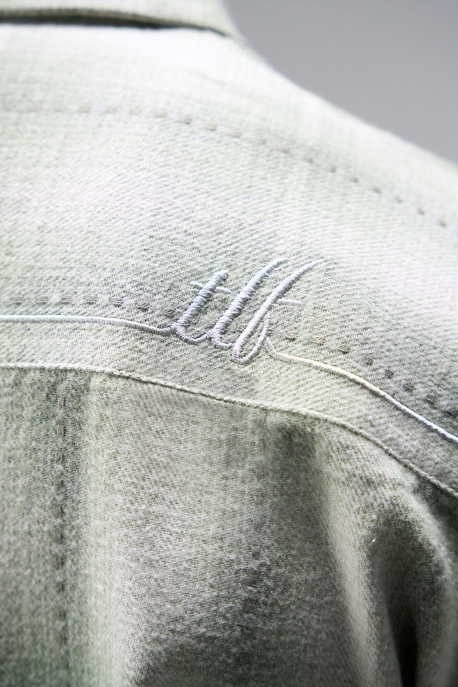 Back View of the Green TLF GTS Flannel Shacket crafted in premium cotton plaid flannel with elevated embroidery details on the collar and back