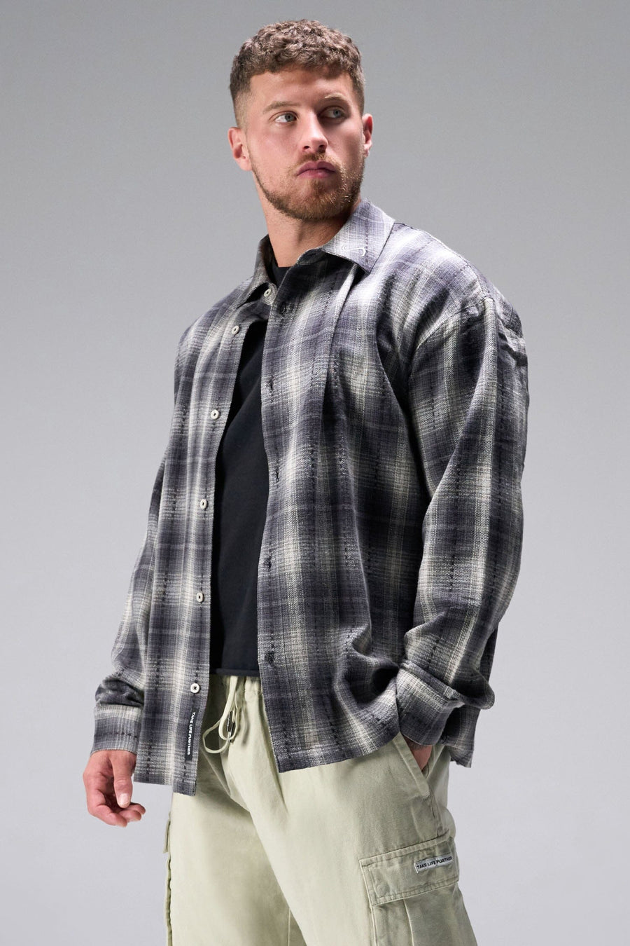 Front View of the Black TLF GTS Flannel Shacket crafted in premium cotton plaid flannel with elevated embroidery details on the collar and back