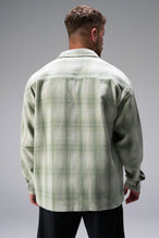 Back View of the Green TLF GTS Flannel Shacket crafted in premium cotton plaid flannel with elevated embroidery details on the collar and back
