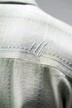 Detail View of the Green TLF GTS Flannel Shacket crafted in premium cotton plaid flannel with elevated embroidery details on the collar and back