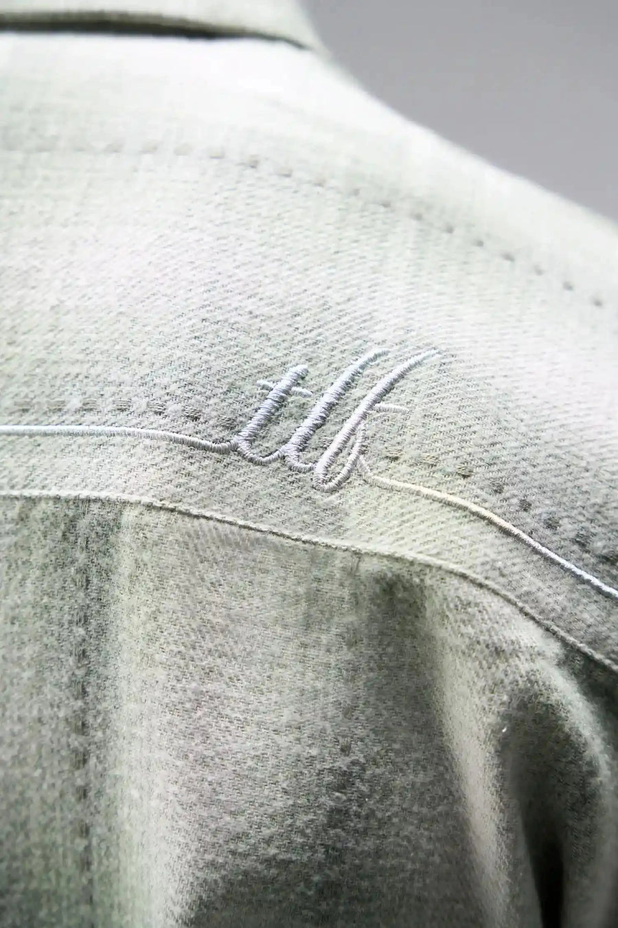 Detail View of the Green TLF GTS Flannel Shacket crafted in premium cotton plaid flannel with elevated embroidery details on the collar and back