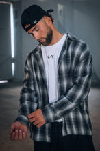 Front View of the Black TLF GTS Flannel Shacket crafted in premium cotton plaid flannel with elevated embroidery details on the collar and back