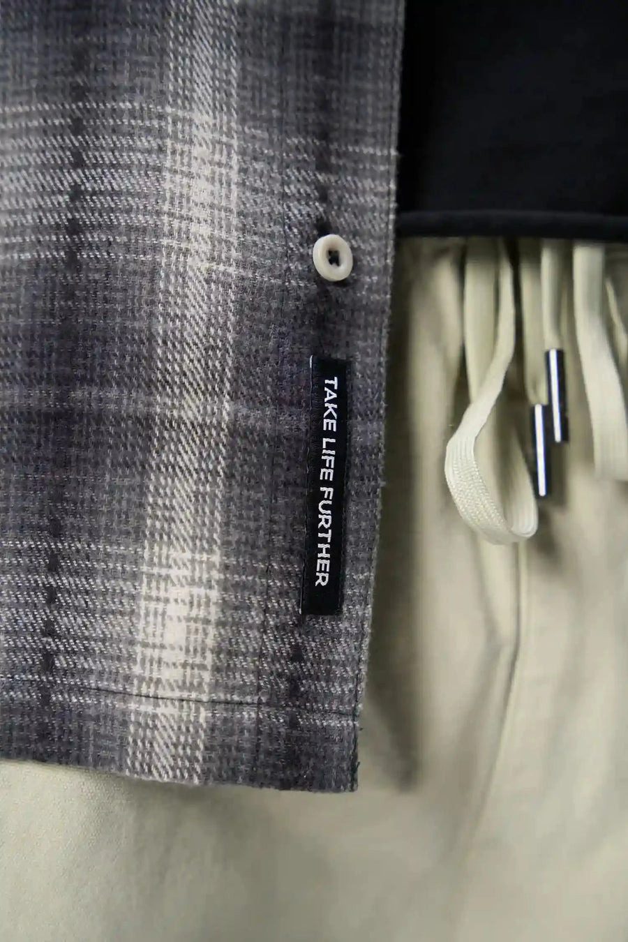 Detail Front View of the Black TLF GTS Flannel Shacket crafted in premium cotton plaid flannel with elevated embroidery details on the collar and back