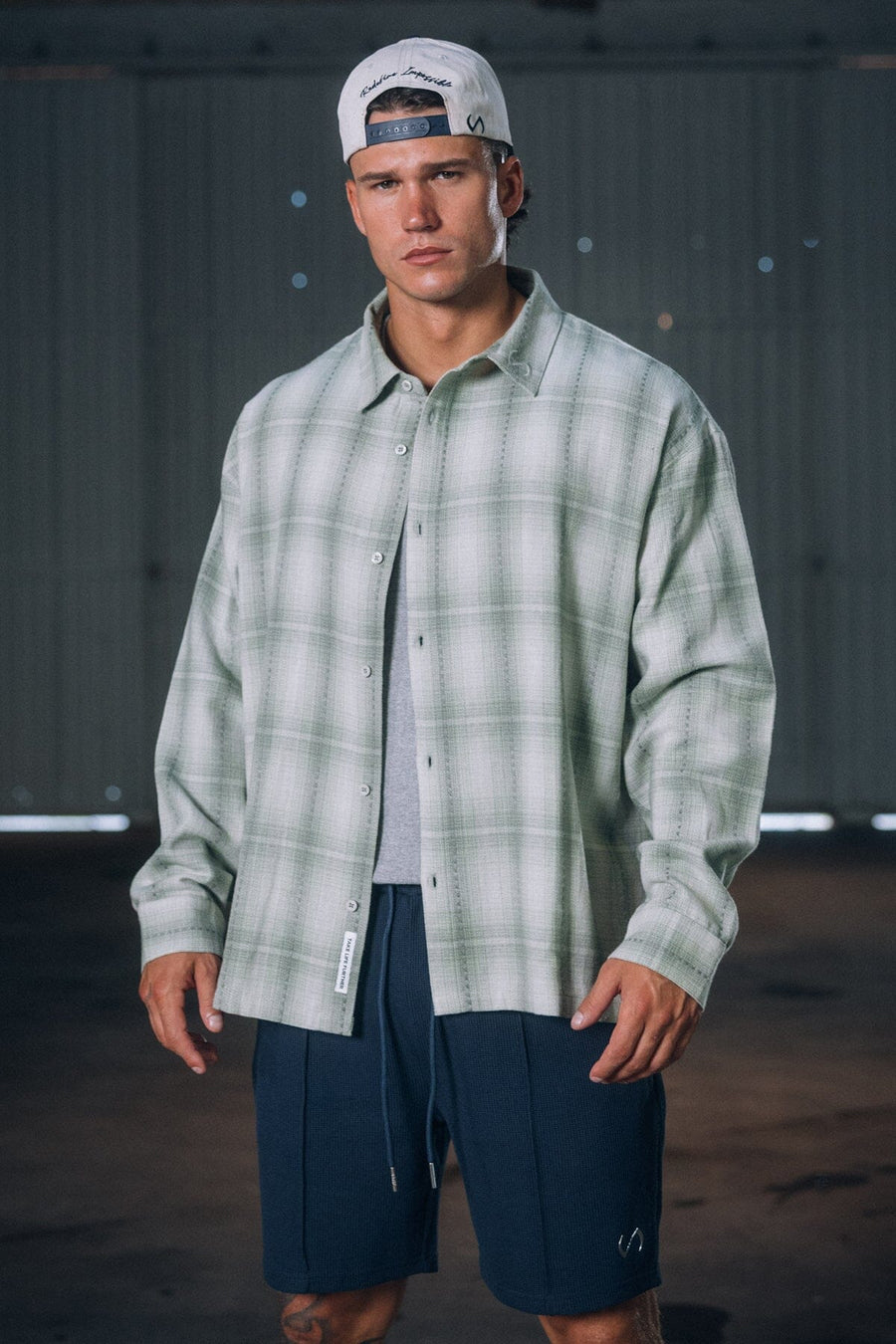 Front View of the Green TLF GTS Flannel Shacket crafted in premium cotton plaid flannel with elevated embroidery details on the collar and back