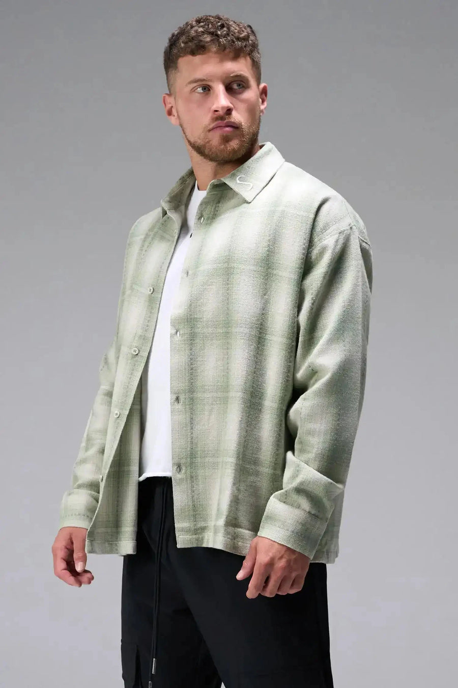 Front View of the Green TLF GTS Flannel Shacket crafted in premium cotton plaid flannel with elevated embroidery details on the collar and back