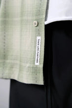 Detail View of the Green TLF GTS Flannel Shacket crafted in premium cotton plaid flannel with elevated embroidery details on the collar and back