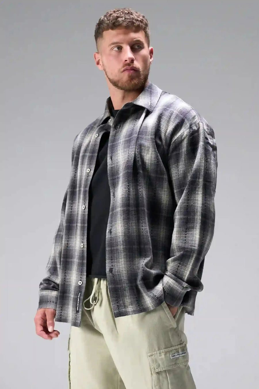 Front View of the Black TLF GTS Flannel Shacket crafted in premium cotton plaid flannel with elevated embroidery details on the collar and back