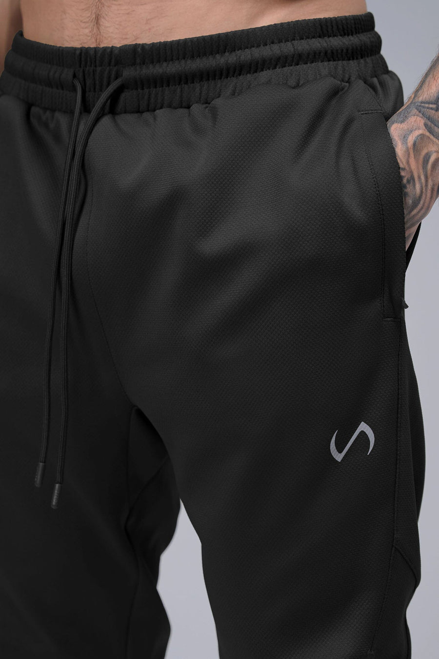 Detail Front View of Black TLF Quad Tech Joggers  featuring a fusion of performance, comfort, and style for the ultimate in mens jogger pants