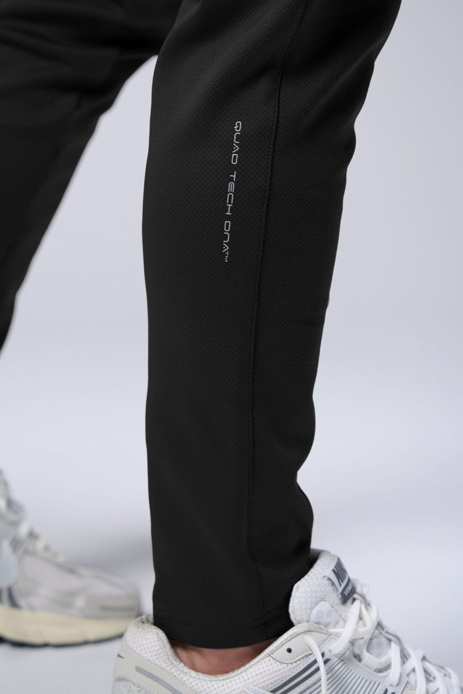 Close-up look of Black TLF Quad Tech Joggers lower leg section featuring a fusion of performance, comfort, and style for the ultimate in mens jogger pants