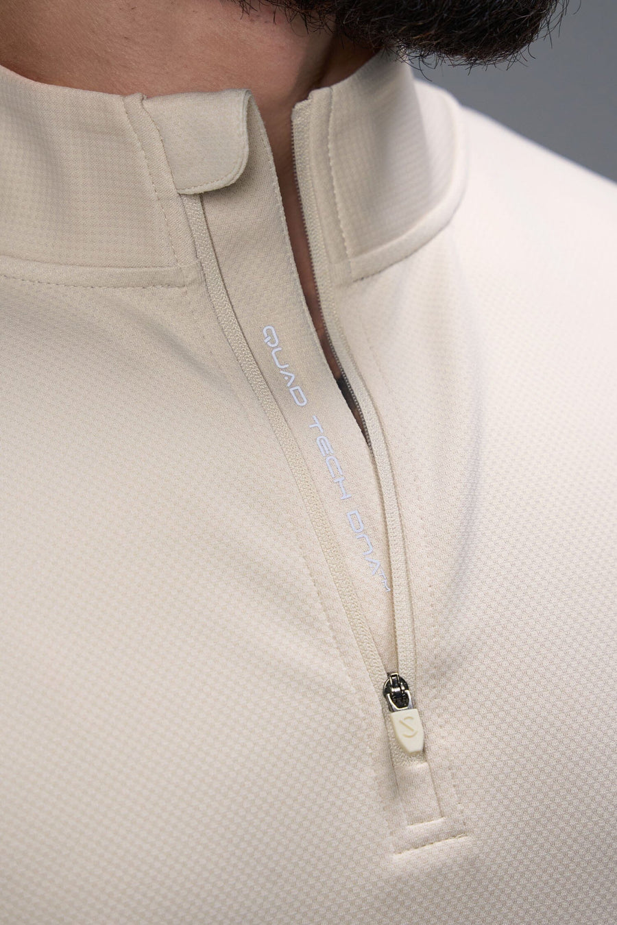 Detail Zip View of Oat Milk TLF GTS Quad Tech Quarter-Zip Pullover redefining modern activewear, this men’s 1/4 zip pullover blends technology with sleek style 