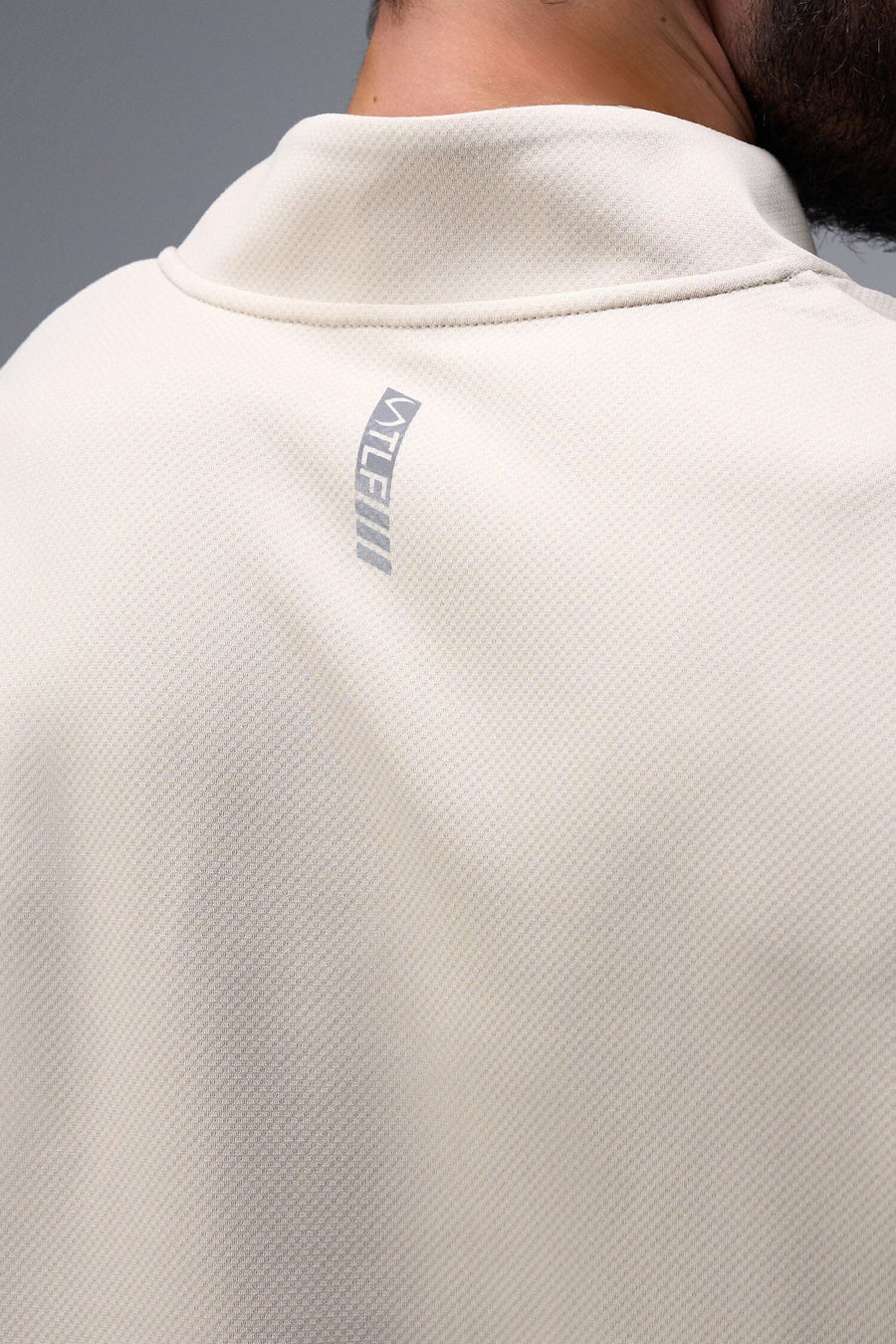 Front View of Oat Milk TLF GTS Quad Tech Quarter-Zip Pullover redefining modern activewear, this men’s 1/4 zip pullover blends technology with sleek style 