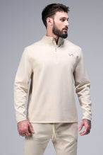 Front View of Oat Milk TLF GTS Quad Tech Quarter-Zip Pullover redefining modern activewear, this men’s 1/4 zip pullover blends technology with sleek style 