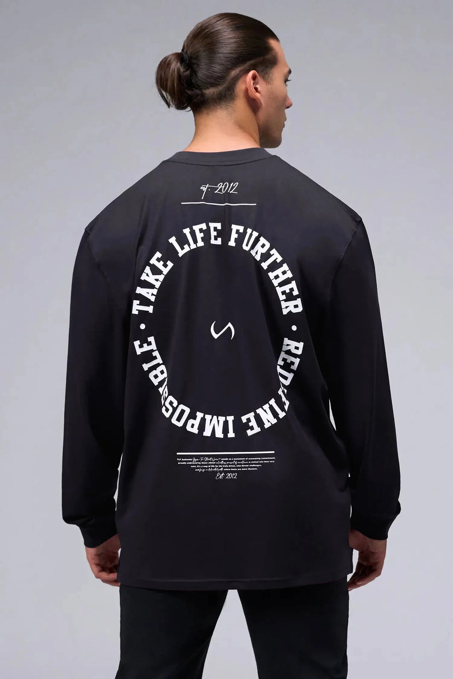 Back View of Black the TLF Redefine Original Cotton Luxe Oversized LS Tee that features a bold back graphic in an oversized fit. 
