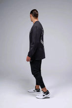 Side View of Black the TLF Redefine Original Cotton Luxe Oversized LS Tee that features a bold back graphic in an oversized fit. 