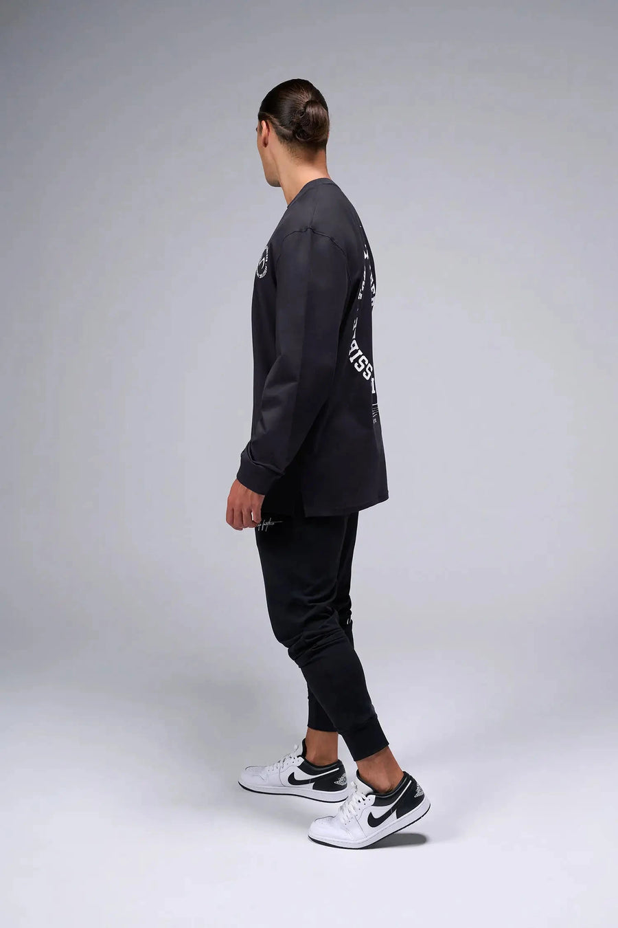 Side View of Black the TLF Redefine Original Cotton Luxe Oversized LS Tee that features a bold back graphic in an oversized fit. 