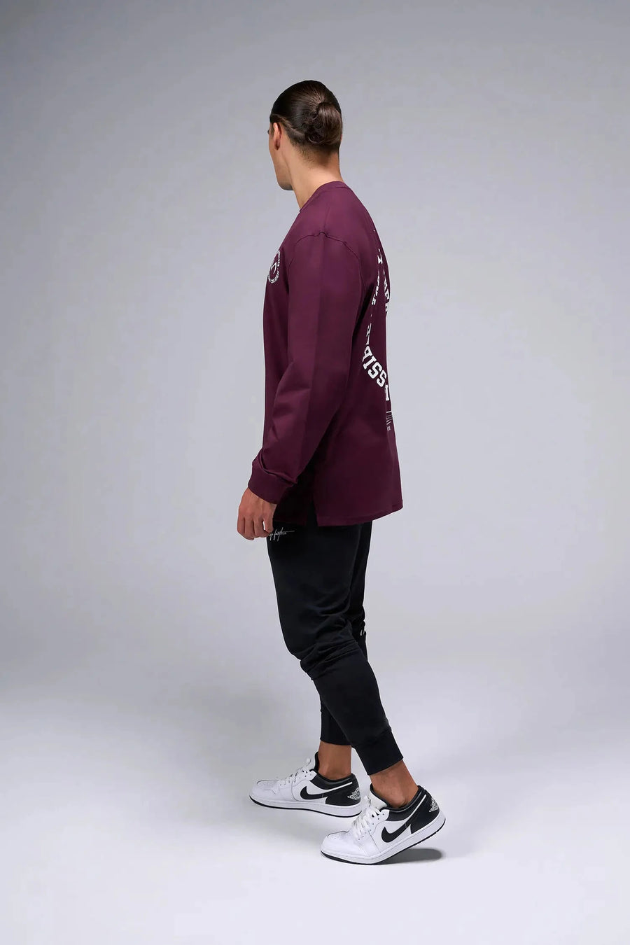 Side View of Red the TLF Redefine Original Cotton Luxe Oversized LS Tee that features a bold back graphic in an oversized fit. 