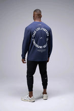 Back View of Blue the TLF Redefine Original Cotton Luxe Oversized LS Tee that features a bold back graphic in an oversized fit. 