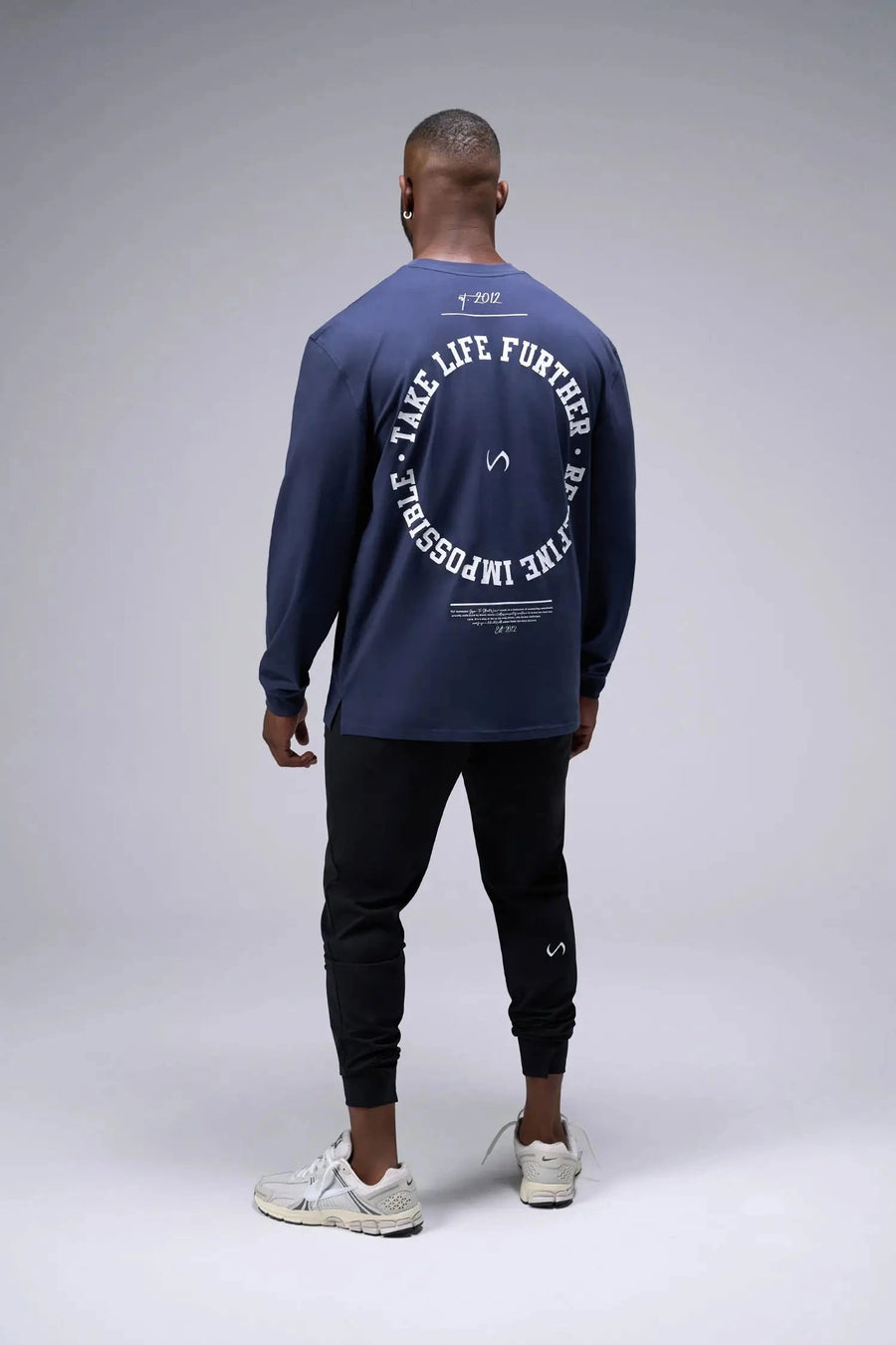 Back View of Blue the TLF Redefine Original Cotton Luxe Oversized LS Tee that features a bold back graphic in an oversized fit. 