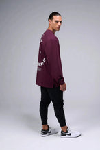 Side View of Red the TLF Redefine Original Cotton Luxe Oversized LS Tee that features a bold back graphic in an oversized fit. 