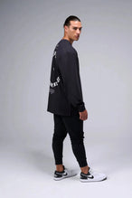 Side View of Black the TLF Redefine Original Cotton Luxe Oversized LS Tee that features a bold back graphic in an oversized fit. 