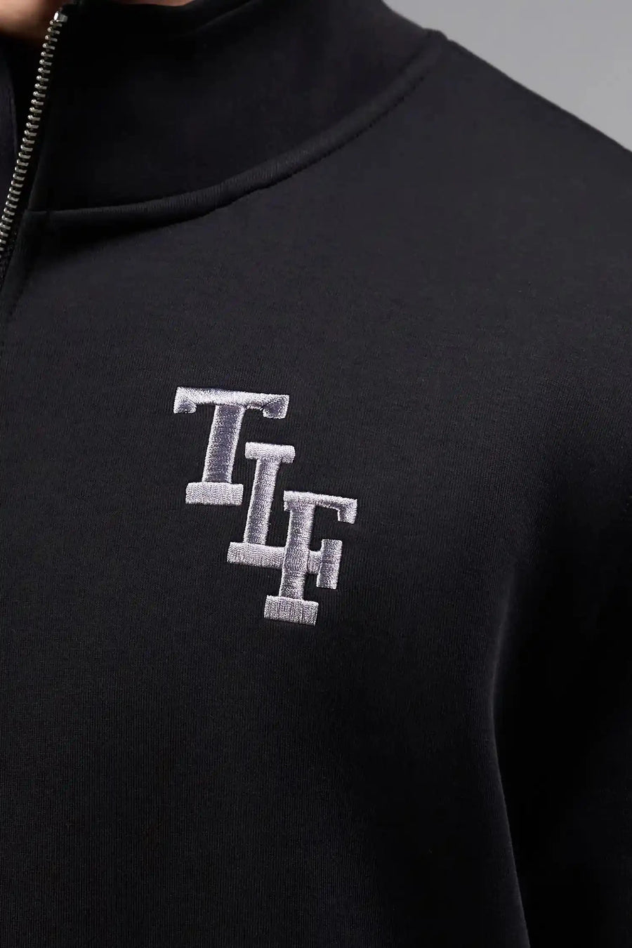 Front View of Black  TLF GTS Scuba Tech Quarter-Zip Pullover, featuring a ¼ zip pullover, sleek design and kangaroo pockets 