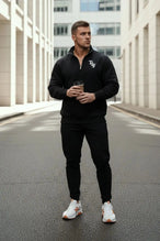 Front View of Black  TLF GTS Scuba Tech Quarter-Zip Pullover, featuring a ¼ zip pullover, sleek design and kangaroo pockets 