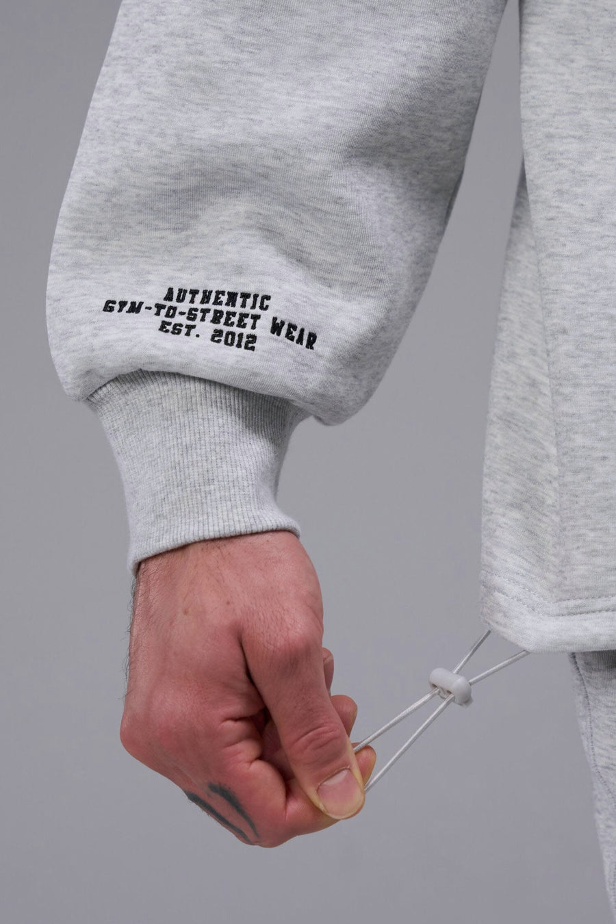 Detail Right Sleeve View of Light Heather Gray TLF GTS Scuba Tech Quarter-Zip Pullover, featuring a ¼ zip pullover, sleek design and kangaroo pockets