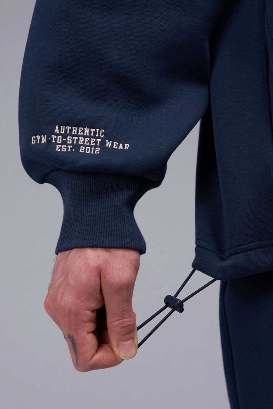 Detail Right Sleeve View of Blue Nights TLF GTS Scuba Tech Quarter-Zip Pullover, featuring a ¼ zip pullover, sleek design and kangaroo pockets