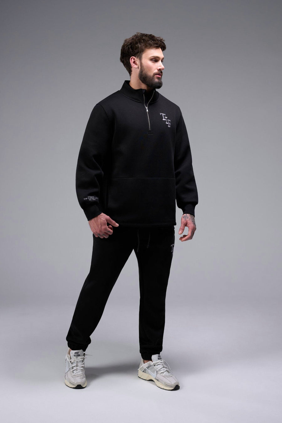 Front View of Black TLF GTS Scuba Tech Quarter-Zip Pullover, featuring a ¼ zip pullover, sleek design and kangaroo pockets