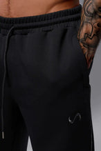 Front View of Black TLF GTS Twill Tech Joggers, featuring contrast stitching, zippered pockets, and next level style and function