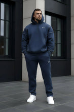 Front View of Blue TLF GTS Twill Tech Joggers, featuring contrast stitching, zippered pockets, and next level style and function