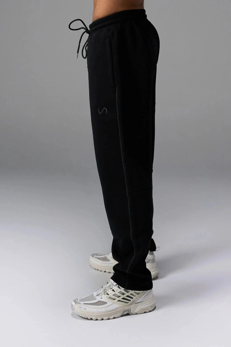 Side View of Black TLF GTS Twill Tech Joggers, featuring contrast stitching, zippered pockets, and next level style and function