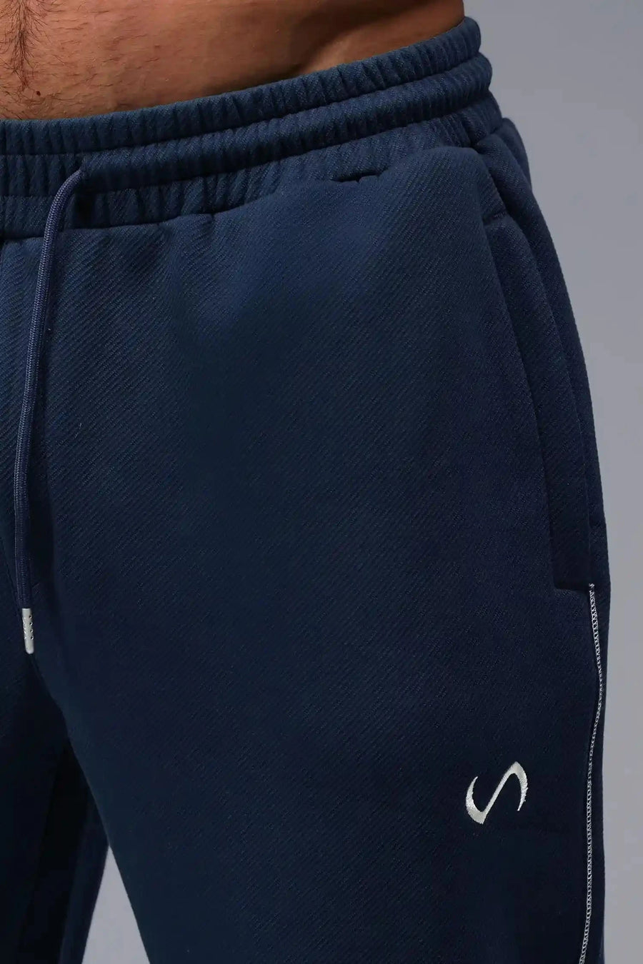 Front View of Blue TLF GTS Twill Tech Joggers, featuring contrast stitching, zippered pockets, and next level style and function