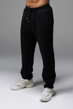 Front View of Black TLF GTS Twill Tech Joggers, featuring contrast stitching, zippered pockets, and next level style and function