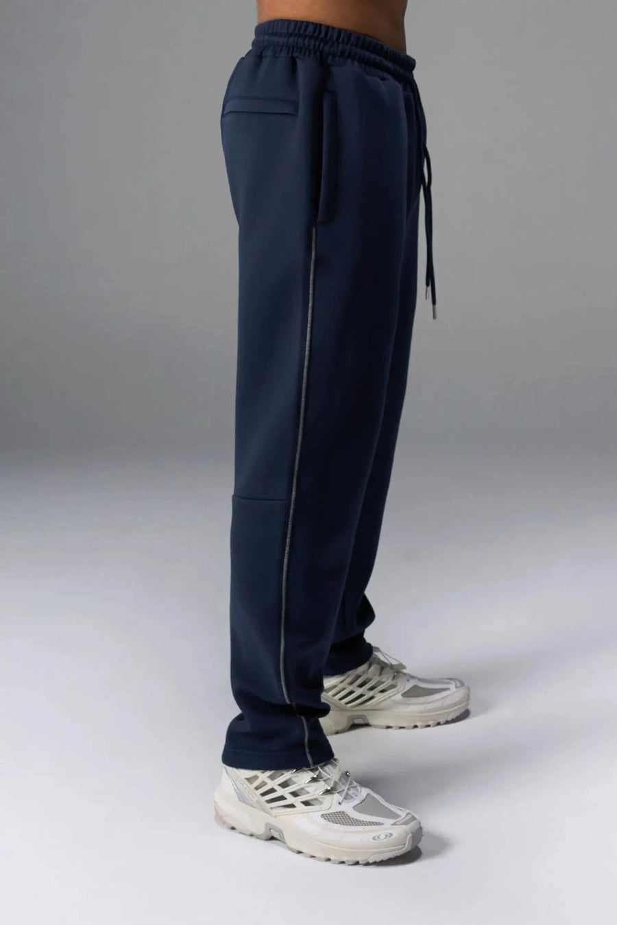 Side View of Blue TLF GTS Twill Tech Joggers, featuring contrast stitching, zippered pockets, and next level style and function