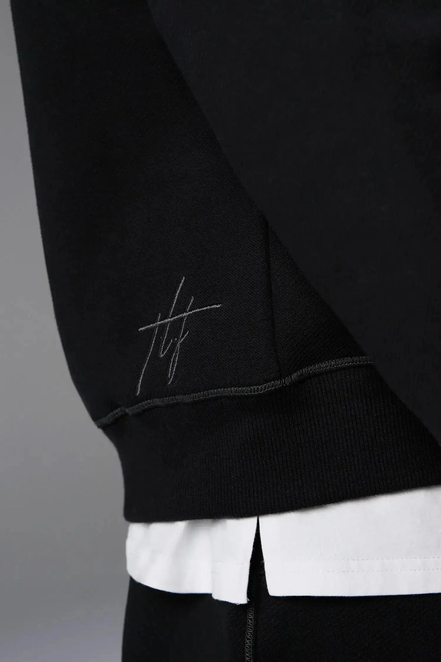 Front View of Black TLF GTS Twill Tech Quarter-Zip Hoodie, featuring contrast stitching, kangaroo pockets and unmatched style