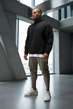 Front View of Black TLF GTS Twill Tech Quarter-Zip Hoodie, featuring contrast stitching, kangaroo pockets and unmatched style