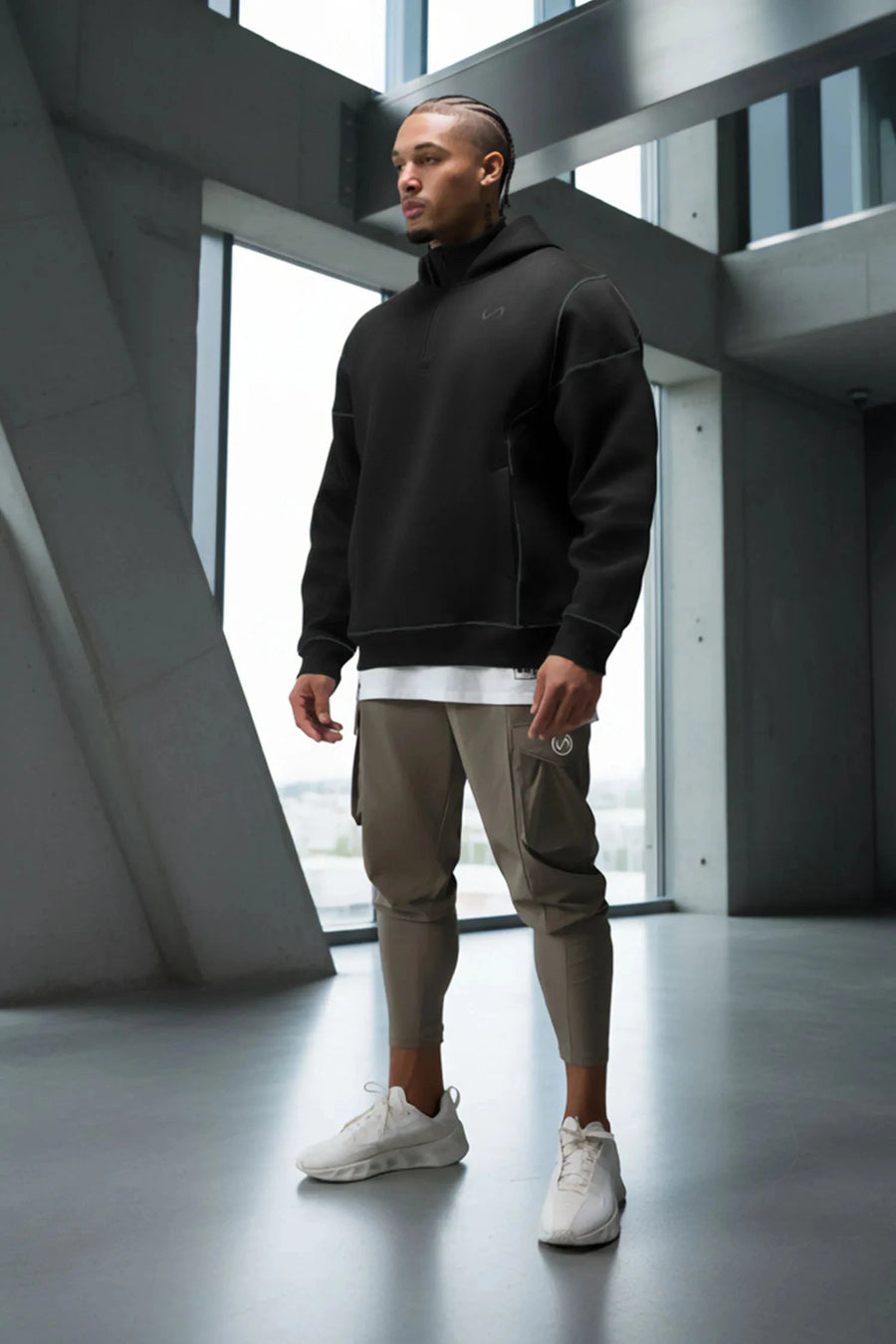 Front View of Black TLF GTS Twill Tech Quarter-Zip Hoodie, featuring contrast stitching, kangaroo pockets and unmatched style