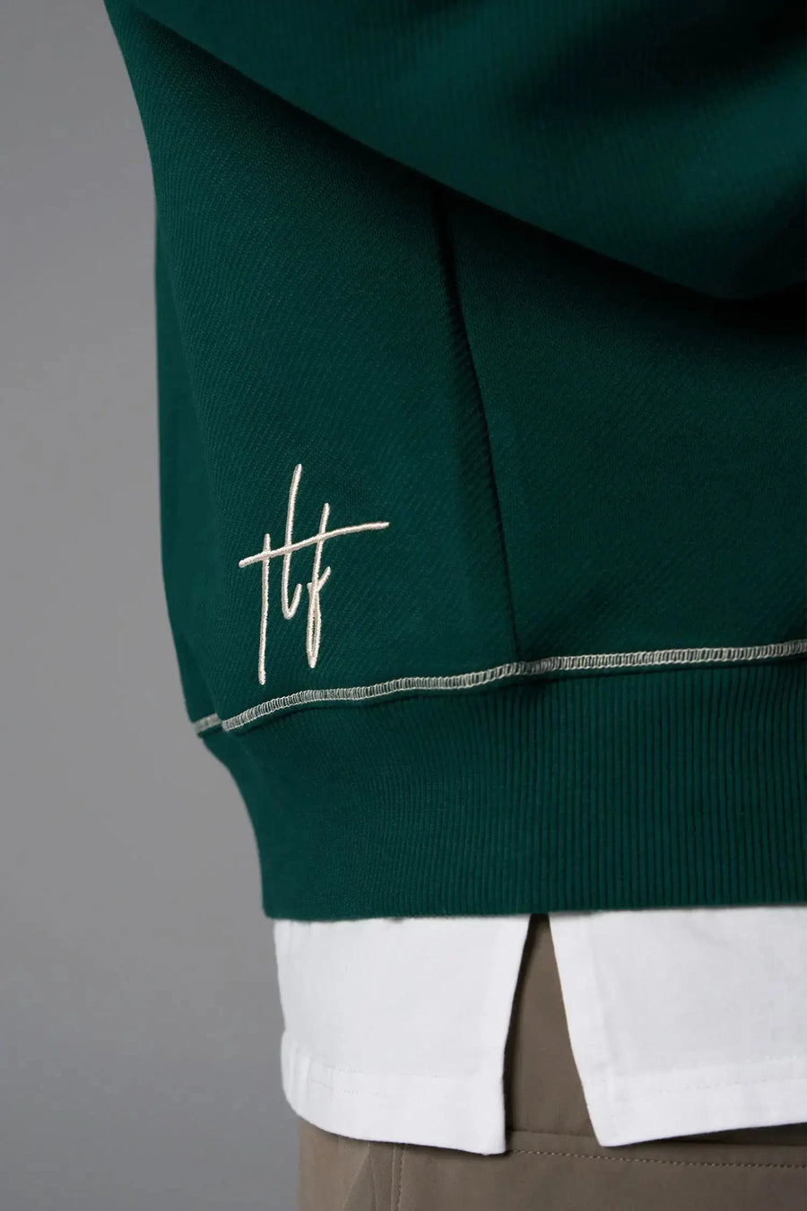 Front View of Green TLF GTS Twill Tech Quarter-Zip Hoodie, featuring contrast stitching, kangaroo pockets and unmatched style