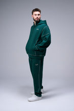 Front View of Dark Harvest Green TLF GTS Twill Tech Quarter-Zip Hoodie, featuring contrast stitching, kangaroo pockets and unmatched style