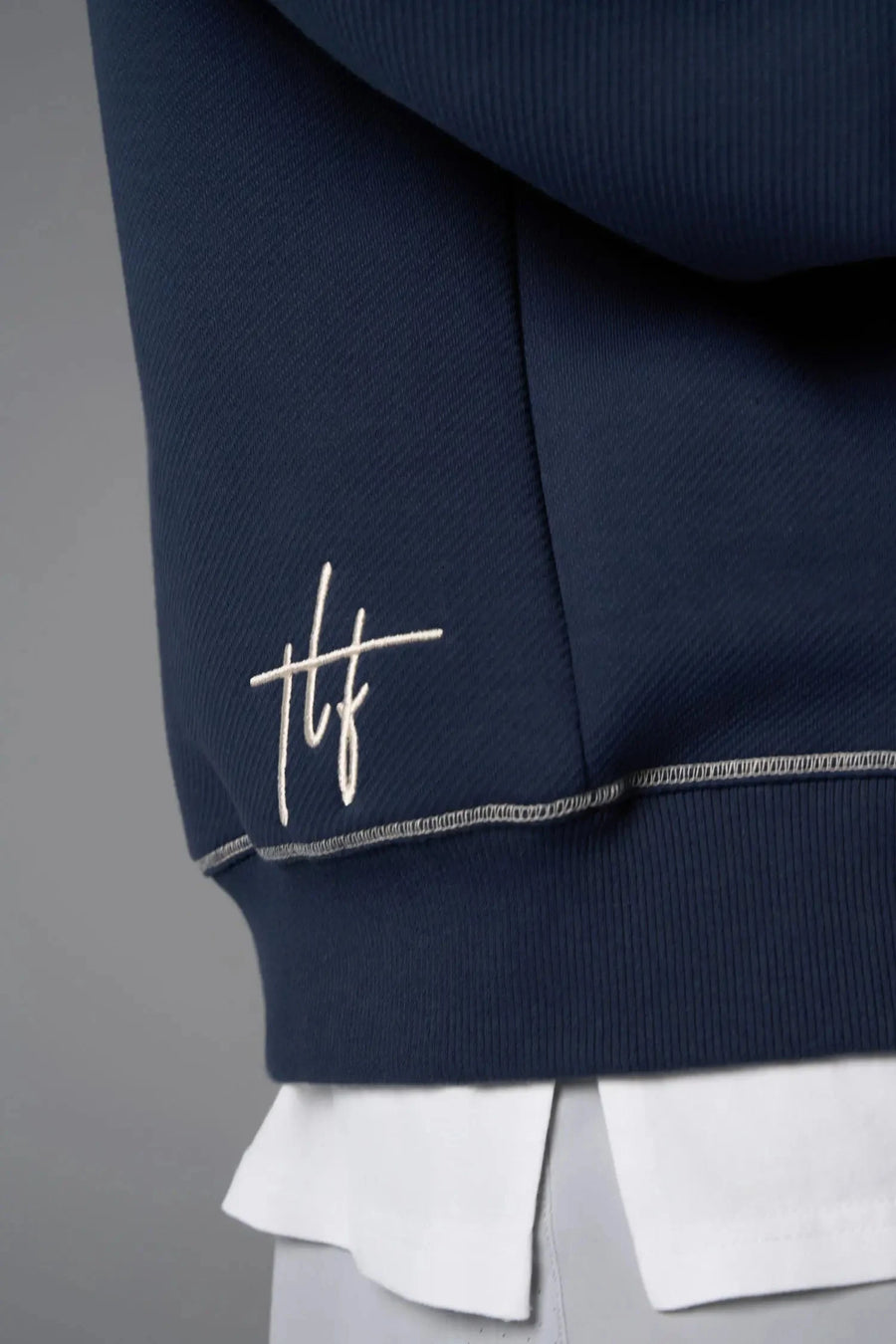 Front View of Blue TLF GTS Twill Tech Quarter-Zip Hoodie, featuring contrast stitching, kangaroo pockets and unmatched style