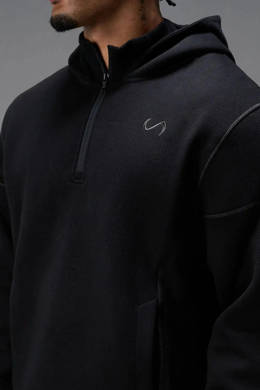 Front View of Black TLF GTS Twill Tech Quarter-Zip Hoodie, featuring contrast stitching, kangaroo pockets and unmatched style