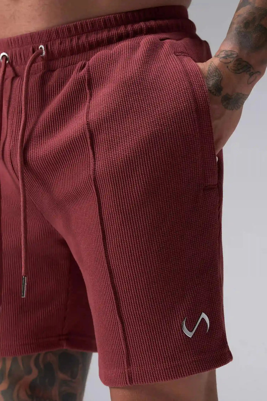 Detail View of Red TLF GTS Waffle Tech Shorts, featuring a 7 Inch inseam, an athletic relaxed fit with zipper pockets designed for all day wear