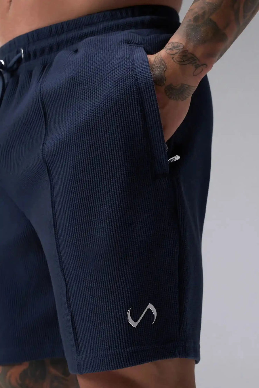 Detail View of Blue TLF GTS Waffle Tech Shorts, featuring a 7 Inch inseam, an athletic relaxed fit with zipper pockets designed for all day wear