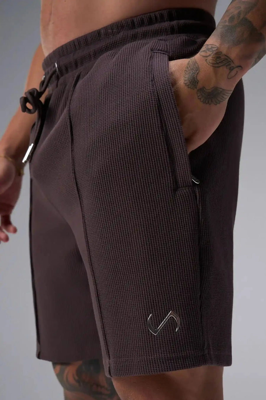 Detail View of Red TLF GTS Waffle Tech Shorts, featuring a 7 Inch inseam, an athletic relaxed fit with zipper pockets designed for all day wear