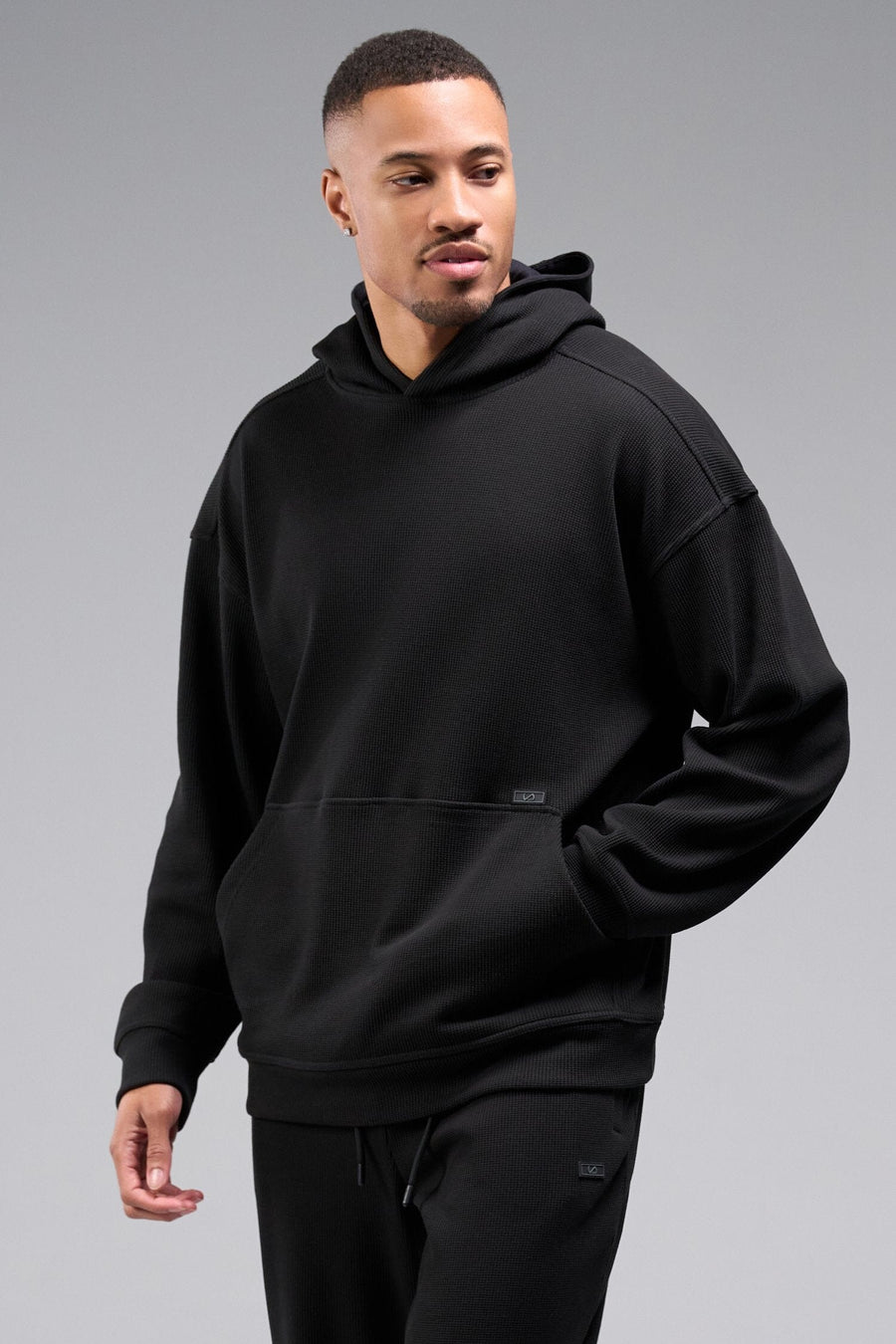 Front View of Black TLF GTS Waffle Tech Hoodie, featuring kangaroo pockets, and double panel hoodie designed for all day wear
