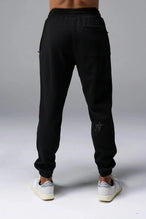 Back View of Black TLF GTS Waffle Tech Joggers, featuring an athletic relaxed fit with zipper pockets designed for all day wear