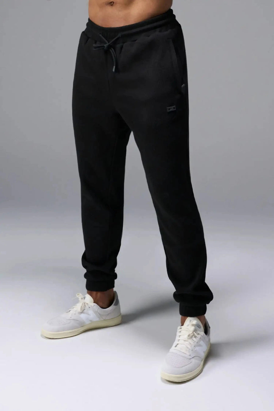 Front View of Black TLF GTS Waffle Tech Joggers, featuring an athletic relaxed fit with zipper pockets designed for all day wear