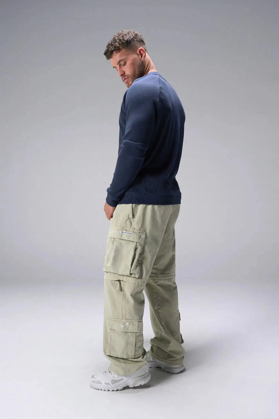 Side View of Blue the TLF Waffle Tech Crew Neck featuring a raglan sleeve in our premium waffle knit fabric